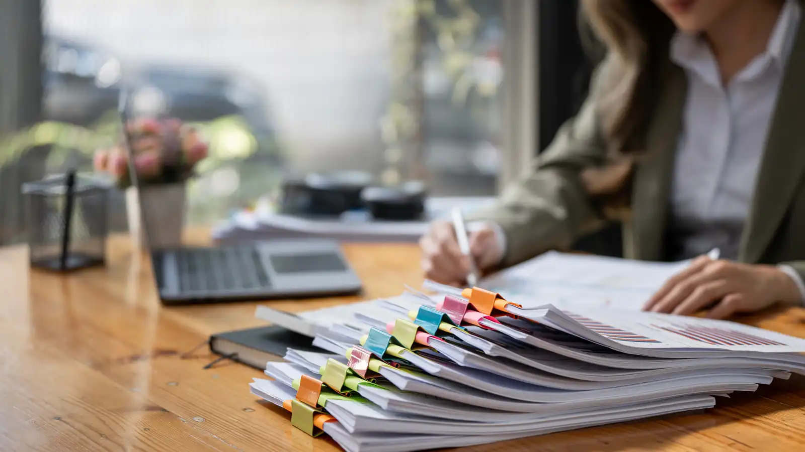 Accountant reviewing financial records to help avoid management rights bookkeeping mistakes
